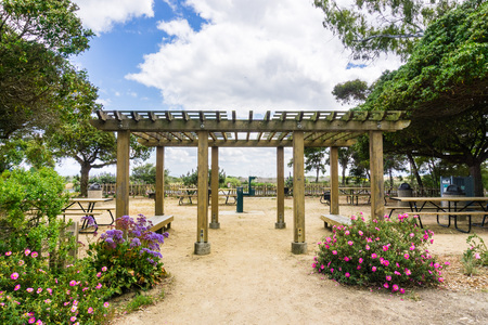 Picnic area with tables, grills and water in Palo Alto Baylands Park, south San Francisco bay, Californiaの写真素材