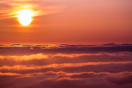 Bright sunlight reflected on a sea of clouds before sunsetの写真素材