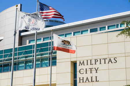April 30, 2017 Milpitas/CA/USA - The City Hall Building on a sunny spring day; the City of Milpitas, USA and the State of California flags blowing in the windのeditorial素材