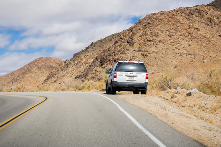 March 17, 2018 Joshua Tree NP / CA / USA - Ranger car stopped on the side of a paved roadのeditorial素材