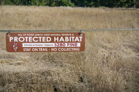 November 5, 2017 Carmel-By-The-Sea/USA - "Protected Habitat, Stay on trail - no collecting" sign in Point Lobos Stare Reserve, a marine reserve near Monterey on the coast of the Pacific Ocean, CA;のeditorial素材