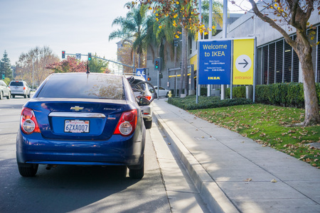 December 9, 2017 East Palo Alto / CA / USA - Cars waiting in line to enter the IKEA parking lot; Welcome to IKEA sign and store hours displayed at the entrance; San Francisco bay areaのeditorial素材