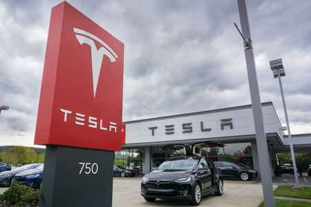 November 2, 2017 Sunnyvale/CA/USA - Tesla logo and cars displayed in front of a showroom located in San Francisco bay area; cloudy sky in the backgroundのeditorial素材