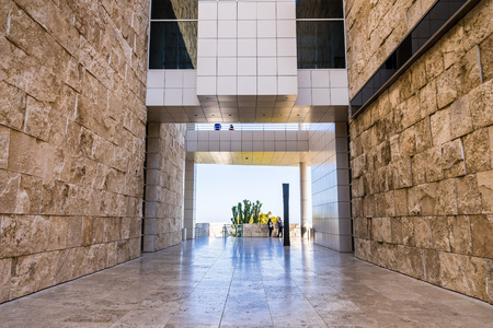 June 8, 2018 Los Angeles / CA / USA - Walking corridor between travertine covered walls and below an aerial walkway connecting buildings at the Getty Center;のeditorial素材