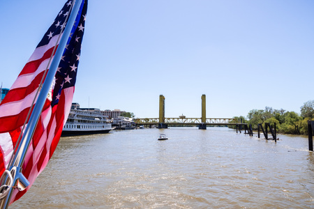 April 14, 2018 Sacramento / CA / USA - View towards the Tower Bridge from the deck of a cruise taking tourists on Sacramento riverのeditorial素材