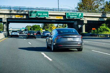 April 21, 2018 Mountain View / CA / USA - The new Model 3 Tesla driving on the freeway in Silicon...