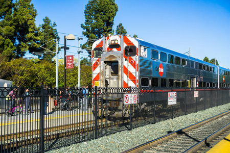 April 20, 2018 Mountain View / CA / USA - Commuters waiting on the platform to take the Caltrain...