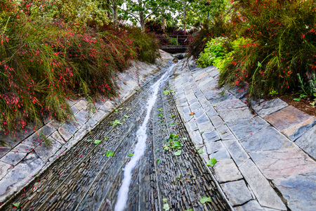 June 8, 2018 Los Angeles / CA / USA - Lush vegetation surrounding a water creek flowing through Robert Irwin's Central Garden at the Getty Center;のeditorial素材
