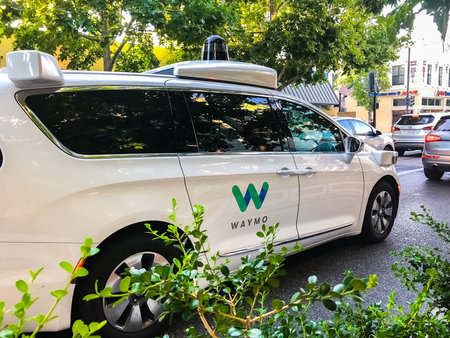 July 20, 2018 Mountain View / CA / USA - Waymo self driving car cruising on a busy street in south...