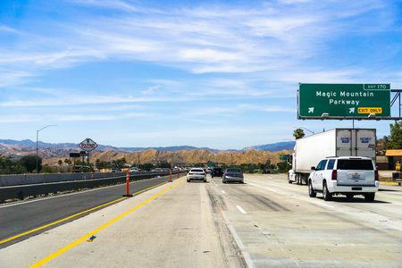 June 10, 2018 Valencia / CA / USA - Driving on the interstate, passing the banner and exit for Six Flags Magic Mountainのeditorial素材