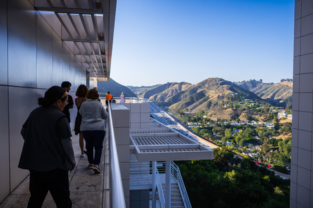 June 8, 2018 Los Angeles / CA / USA - Group of visitors on the free architectural tour at Getty Center; the highway and nearby hills visible in the backgroundのeditorial素材