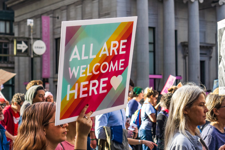 January 19, 2019 San Francisco / CA / USA - Participants to the Women's March event holds "All are welcome here" sign while marching on Market street in downtown San Franciscoのeditorial素材