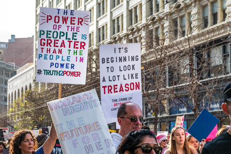January 19, 2019 San Francisco / CA / USA - Participants to the Women's March event hold signs with various massages while marching on Market street in downtown San Franciscoのeditorial素材
