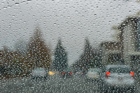 Raindrops on the windshield while driving on a rainy day, California