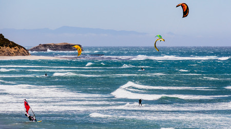 June 6, 2019 Davenport / CA / USA - People kite and wind surfing in the Pacific Ocean, near Santa Cruz, on a sunny and warm dayのeditorial素材