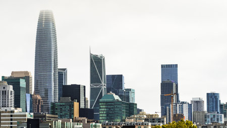 San Francisco financial district skyline, with new and modern skyscrapers, on a cloudy day;...