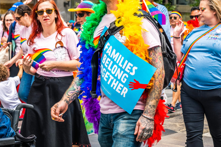 June 30, 2019 San Francisco / CA / USA - Unidentified participant carrying the political message sign Families Belong Together at the SF Pride Parade on Market Street in downtown San Franciscoのeditorial素材