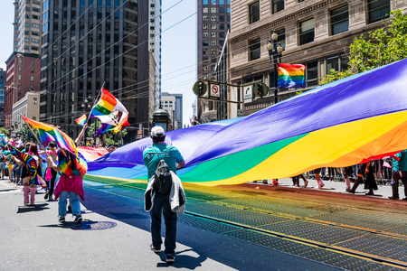 June 30, 2019 San Francisco / CA / USA - Giant LGBT Pride Flag carried at the SF Pride Parade on Market Street in downtown San Franciscoのeditorial素材