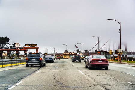 July 4, 2019 San Francisco / CA / USA - Driving towards the Golden Gate Bridge; the Golden Gate Bridge barely visible in the fog, in the backgroundのeditorial素材
