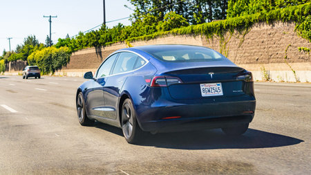 July 4, 2019 Redwood City / CA / USA - The Model 3 Tesla driving on the freeway in San Francisco bay...