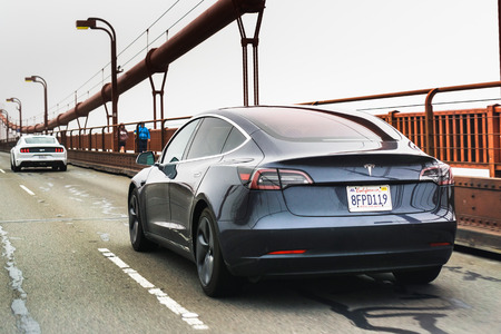 July 4, 2019 San Francisco / CA / USA - Model 3 Tesla driving on the Golden Gate Bridgeのeditorial素材