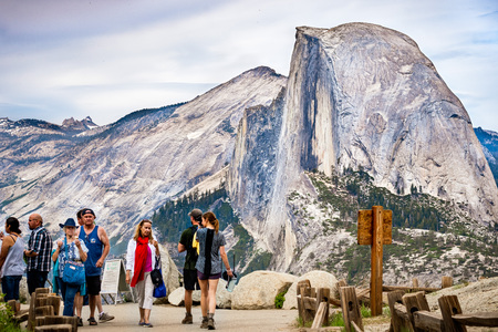 June 27, 2019 Yosemite National Park / CA / USA - Unidentified people visiting Glacier Point; Half Dome visible in the backgroundのeditorial素材
