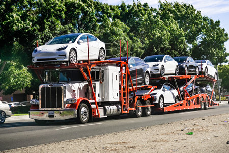 June 28, 2019 Fremont / CA / USA - Car transporter carries Tesla Model 3 new vehicles from the...