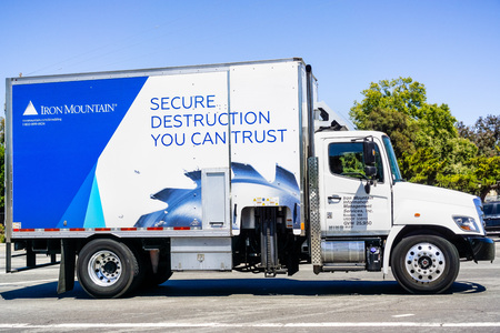 July 12, 2019 Santa Clara / CA / USA - Iron Mountain vehicle driving on a street; Iron Mountain Inc. is an American company that provides records management and data destruction, backup and recoveryのeditorial素材