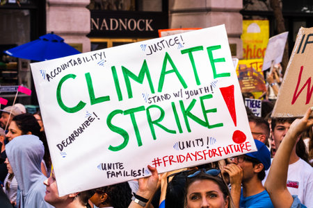 Sep 20, 2019 San Francisco / CA / USA - Protester raising Climate Strike sign at the Climate Strike...
