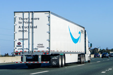 August 24, 2019 Redwood City / CA / USA - Amazon truck driving on the freeway, the large Prime logo...