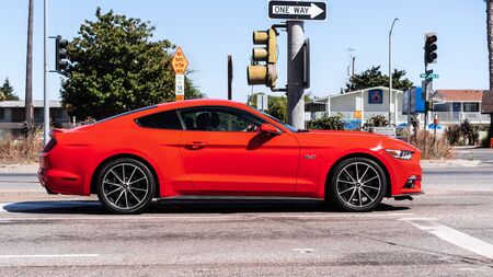 September 1, 2019 Sunnyvale / CA / USA - Orange colored Ford Mustang side viewのeditorial素材