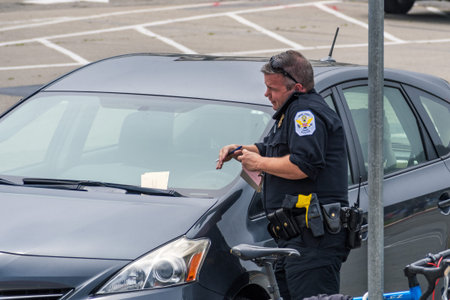 August 10, 2019 San Francisco / CA /USA - US Park Police officer writing a parking ticket in...