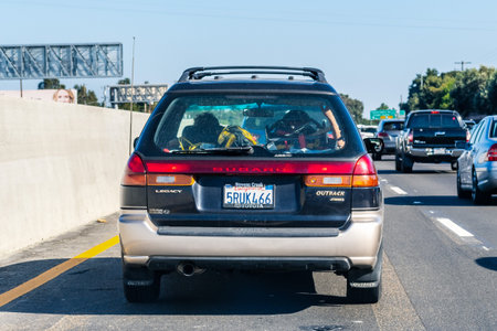 Sep 26, 2019 Mountain View / CA / USA - Subaru Outback driving on the freeway; Rear view of the...