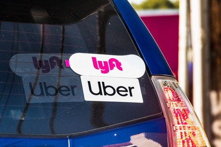 Oct 10, 2019 Mountain View / CA / USA - Lyft and UBER stickers on the rear window of a vehicle...