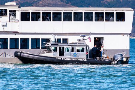 Oct 12, 2019 San Francisco / CA / USA - San Francisco Police Department vessel stopped next to a cruising ship; San Francisco Fleet Week eventのeditorial素材