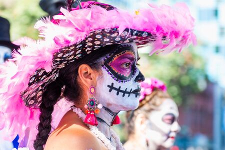Oct 20, 2019 San Jose / CA / USA - Portrait of a woman with sugar-skull make-up, participating at Dia de Los Muertos (Day of the Dead) procession taking place in South San Francisco Bayのeditorial素材