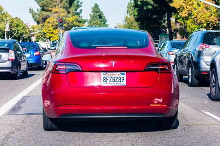 August 5, 2019 Mountain View / CA / USA - Rear view of red Tesla Model 3 driving on a street in Silicon Valleyのeditorial素材