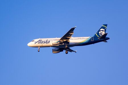 Nov 23, 2019 San Francisco / CA / USA - Sunset view of Alaska Airlines aircraft approaching San Francisco International Airport (SFO) and preparing for landing; blue sky backgroundのeditorial素材