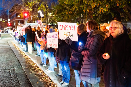 Dec 17, 2019 Mountain View / CA / USA - Protesters carrying signs at the Impeachment Eve Vigil rally...