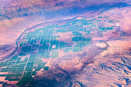 Aerial view of agricultural fields on the Colorado River valley in Arizona, at the border with California; the City of Parker visible in the right upper cornerの写真素材