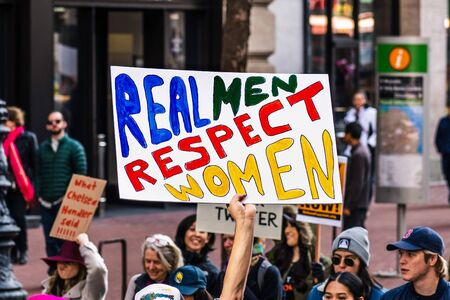 Jan 18, 2020 San Francisco / CA / USA - Participant to the Women's March event holds "Real Men Respect Women" sign while marching on Market street in downtown San Franciscoのeditorial素材