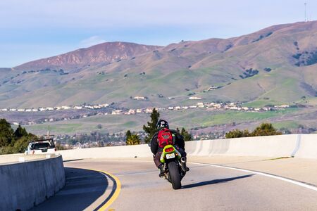 Jan 3, 2020 Milpitas / CA / USA - Motorcyclist riding on the carpool lane in South San Francisco Bay Area; Motorcycles are permitted by federal law to use HOV lanes, even with only one passengerのeditorial素材