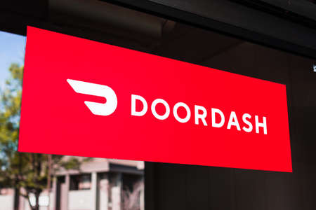 Feb 27, 2020 Santa Clara / CA / USA - Close up of Doordash logo and symbol displayed at the entrance to one of their offices; DoorDash Inc. is a on-demand prepared food delivery serviceのeditorial素材