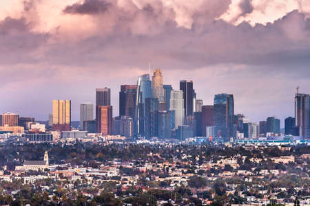Dec 8, 2019 Los Angeles / CA / USA - Sunset view of the Financial District skyline and surrounding area with storm clouds covering the sky; Bank business logos visible on the skyscrapers exteriorのeditorial素材
