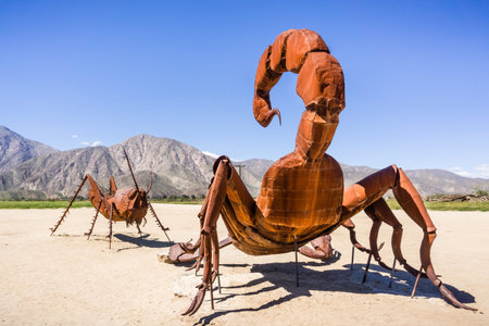 Mar 18, 2019 Borrego Springs / CA / USA - Sculpture of a scorpion fighting a grasshopper, close to...