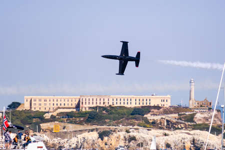Oct 12, 2019 San Francisco / CA / USA - The Patriots jet flying in front of Alcatraz Island during Fleet Week; The Patriots is a civilian aerobatic formation team flying Aero L-39 Albatros jetsのeditorial素材