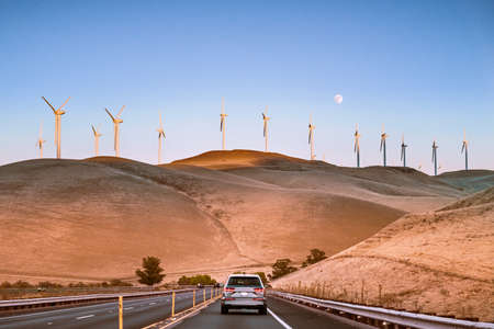Sunset view of wind turbines visible on the golden hills of Contra Costa County; San Francisco Bay Area, Californiaの写真素材