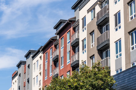 Exterior view of modern apartment building offering luxury rental units in Silicon Valley;...