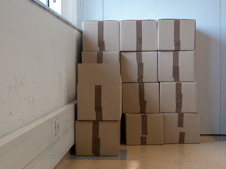 Cardboard boxes stacked against the wallの写真素材