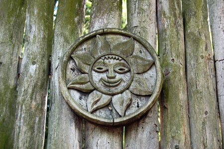 carving with wooden sun on the antique fence の写真素材